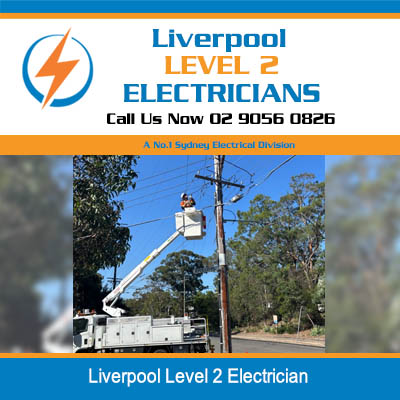 Level 2 electrician in elevated cherry picker working on overhead power lines in Liverpool